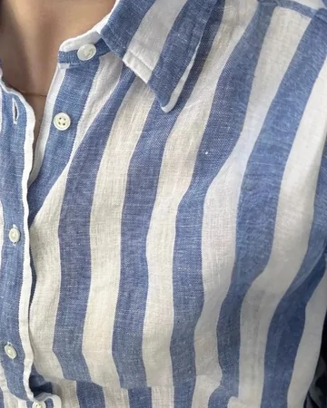 Close view of a blue and white striped linen shirt: collar, placket and buttons